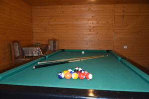 a pool table with balls on top of it at Pensiunea Poiana in Borşa
