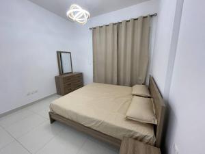 a bedroom with a bed and a mirror in it at Newly Furnished Studio in Elite in Dubai