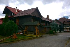 a house with a playground in front of it at Pensiunea Poiana in Borşa