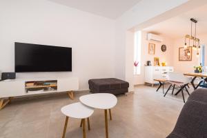a living room with a flat screen tv on a wall at Infinity Dalmatia Apartments in Vinjerac
