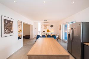 a kitchen and dining room with a table and a refrigerator at Infinity Dalmatia Apartments in Vinjerac