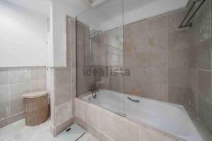 a bathroom with a tub and a glass shower at Moderno Loft - Beach & Golf in Marbella +14 photos