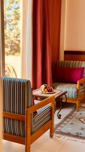uma sala de estar com duas cadeiras e uma mesa em Hotel Idou Tiznit em Tiznit