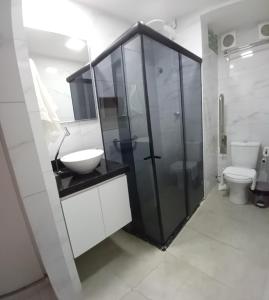 a bathroom with a sink and a shower and a toilet at No coração de Boa Viagem in Recife