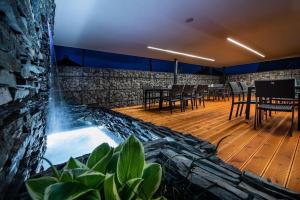 a hot tub in a restaurant with tables and chairs at Hotel ZEMPLEN in Michalovce