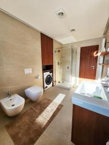 a bathroom with a sink and a washing machine at Vila Stašov in Polička +18 photos