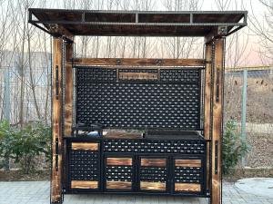 a black and wooden structure with a bunch of wine bottles at Apartamente CasaBella in Baile Felix