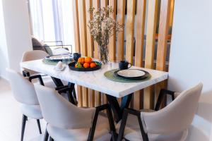 a dining room table with a bowl of fruit on it at Mi casa su casa in Néa Koútali +20 photos
