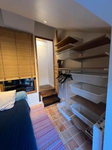 a room with a bed and some shelves at rhoazon heart in Rennes