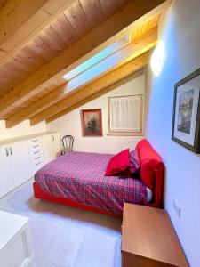 a bedroom with a bed in a room with wooden ceilings at Ledrobenessere in Pieve Di Ledro
