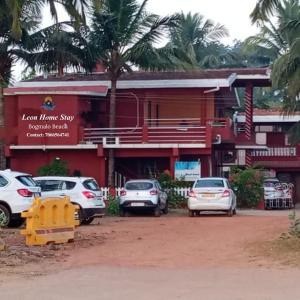 a group of cars parked in front of a building at LEON HOME STAY in Bogmalo