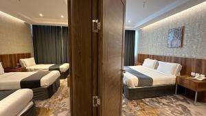 Postel nebo postele na pokoji v ubytování Multazam Al-Nnaseem Hotel