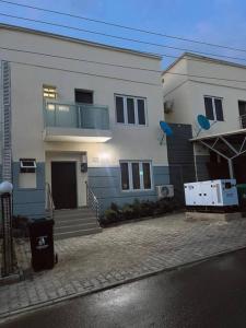 a large white house with a balcony on it at aPogee Home in Abuja