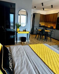 a living room with a bed and a kitchen at Capital Towers "FIRST CLASS" in Rzeszów