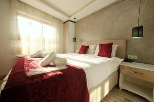 a bedroom with a bed with towels on it at Taksim Celebi Suites in Istanbul