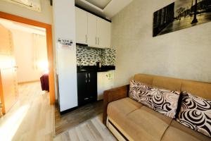 a living room with a couch and a kitchen at Taksim Celebi Suites in Istanbul