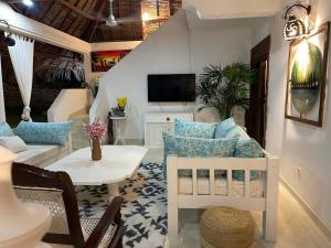 a living room with a couch and a table at Hidden Gem villa in Malindi