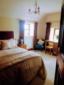 a bedroom with a bed and a desk and a chair at Glenvela in Castlerea