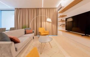 a living room with a couch and a flat screen tv at 4 Bedroom Beautiful Home In Petrcane in Petrcane