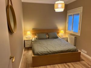 a bedroom with a bed with two night stands and two lamps at Centro in Sant Cugat del Vallès