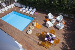 an overhead view of a swimming pool with chairs and a table at Chateau Blanc in Protaras