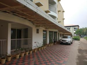 a car parked next to a building with potted plants at Airport Freshups Cochin in Nedumbassery