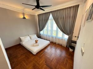 a bedroom with a bed and a ceiling fan at Newly Renovated Seaview 3BR - 8Pax Baby Friendly in Kuah