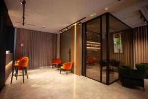 a dining room with orange chairs and a table at Bel Sito Hotel Due Torri in Manocalzati