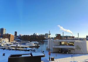 a marina with a building and boats in the water at Modern&Quiet 7th floor Apt with Balcony, Free 5G WIFI, Laukontori in Tampere