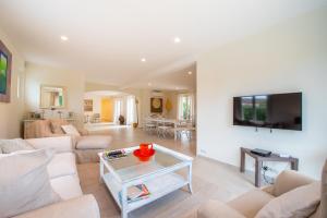 a living room with a couch and a table at Villa le Roi Soleil in Saint-Tropez