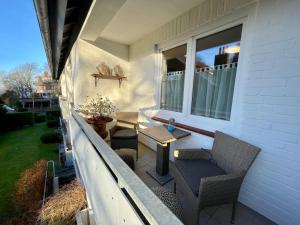 a porch with a table and chairs on a house at Strandliebe Glücksburg in Ulstrupfeld