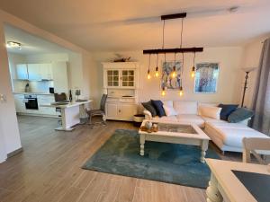 a living room with a couch and a table at Strandliebe Glücksburg in Ulstrupfeld +14 photos