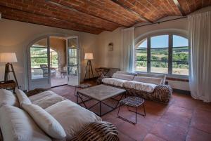 a living room with a couch and a table at Villa La Salina in Bibbona