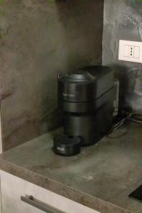 a coffee maker sitting on top of a counter at The Station Bollate Centro in Bollate