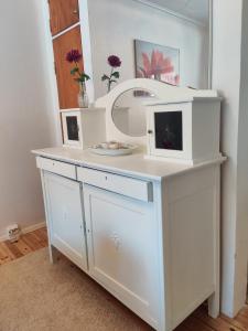 a dressing table with a mirror and a sink at Vintage Retreat in Lahti