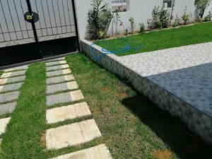 a garden with a stone walkway next to a house at Maison Jazz Vue Sur Mer in Tabarka