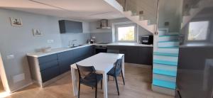 a kitchen with blue cabinets and a table and chairs at Beach house in Cavo