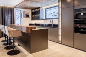 an open kitchen with a wooden counter top and stainless steel appliances at Hollywood Dream Penthouse with private Sauna close Ischgl in Kappl