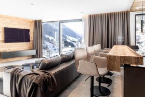 a living room with a couch and a table at Hollywood Dream Penthouse with private Sauna close Ischgl in Kappl