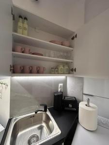 a kitchen with a sink and a counter top at Artemis Beach Holiday Nest 1 in Artemida +49 photos