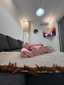 a bed with a pink blanket on top of it at Artemis Beach Holiday Nest 1 in Artemida