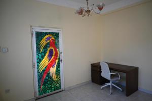a stained glass window of a parrot on a wall at Stylish Hilltop King Bed Apartment with Free Parking and Wifi in Wuţayyah