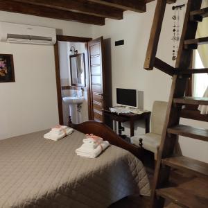 a bedroom with a bed and a desk with a computer at Il Casale della Biodiversità in Scanzano