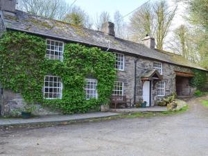 an old stone house with ivy growing on it at Millers Cottage, Broughton - family & pet friendly in Broughton in Furness