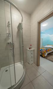 a bathroom with a shower and a bed in a room at Soul Poznan Free Parking in Poznań