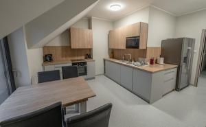a large kitchen with a table and a refrigerator at Soul Poznan Free Parking in Poznań