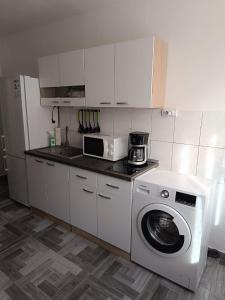 a kitchen with a washing machine and a refrigerator at Novi studio apartman Demy u centru Splita in Split