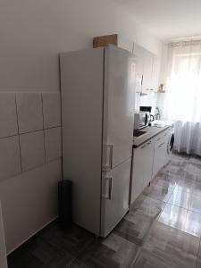 a kitchen with a white refrigerator in a room at Novi studio apartman Demy u centru Splita in Split