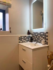 a bathroom with a sink and a mirror at The Smiddy in Lochailort