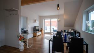 a dining room and living room with a table and chairs at JS-Apartment in Balingen
